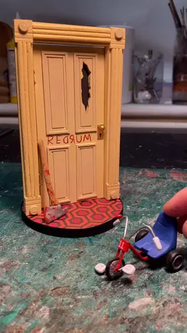 Miniature “The Shining” door and tricycle #fyp #theshining #stanleykubrick #horrorart #miniature #handmadeart