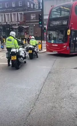 London bus deiver arguing with police escort motorcyclists parking inconsideretly in the middle of the road. Who is in the wrong here?!
