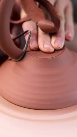 Trimming away at the excess clay left on the bottom of his thrown bowl. This created a foot and its on this the bowl will sit when turned the right way up. #clay #satisfying #handmadecraft #maker #bowl