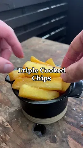 I use Maris Piper potatoes, Agria and Yukon Gold also work well 1. Peel the potatoes and square them off saving the trim for something else like a soup. 2. Cut into even sized chips 2cm square roughly, length doesn’t really matter (lol) 3. Rinse in cold water then add to a pan of cold salted water and bring to a gentle boil for 10 mins until the chips are just fork tender. 4. Drain and dry on a wire rack uncovered in a fridge, when completely chilled they are ready for frying. 5. Heat the oil to 130c drop the chips for 8 mins return to the rack and dry again in a fridge or a freezer. 6. heat the oil to 180c and give them a further 4 mins 7. Sprinkle with sea salt and serve  #potato #potatoes #cooking #fyp 