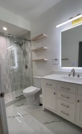 Modern Bathroom  This bathroom is finally finished!!!  From the tiles to the LED Vanity Mirror, we love how everything turned out!  #bathroommakeover #homerenovation #modernhome #bathroominspo #beforeandafter 