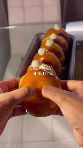 Crème brûlée 🤝🏼 donuts 🤝🏼 me 🥰🥰🥰 Ingredients  Donuts: ¾ cup warm milk  1 ½ tsp yeast  3 ¼ cups flour  1/2 tsp salt  ¼ cup sugar  1 egg 60g unsalted butter  Filling of choice  Caramel: 1 cup sugar  ½ cup water  Steps  1. Mix the milk and yeast and set that aside for 5 minutes.  2. Add all the ingredients with the milk to a bowl and knead until smooth (8-10 minutes).  3. Cover and keep the dough in a warm place for 1 hour.  4. Roll out the dough and cut out the donuts.  5. Leave them to rise for 1 hour.  6. Fry them until golden brown.  7. Fill them with your filling of choice.  8. Add the caramel ingredients to a saucepan and do not stir (it will crystallise).  9. Place it on med-high heat and swirl occasionally until it reaches an amber colour.  10. Carefully dip one side of each donut in the caramel and let it harden.  #donuts #c#donutsl#cremebruleel#cremebruleedonutsp#EasyRecipes##desserte#dessertrecipef#Recipef#Foodie #foodbloge#foodheavenf#tastyer#FoodLovero#comfortfood #cheatday #goodfoodg#foryoupaged#fypo#foodtiktoky#fypシ#foryoui#viralt#nigeriantiktok #uktiktokp#asmrrecipec#aestheticfoodc#aesthetictisfying 
