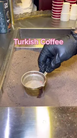 Turkish Coffee🇹🇷☕️ in #Qatar Turkish Coffee prepared using the hot sand method — where sand is heated using an open flame. Finely ground coffee and water (or milk if making a latte) are added to a small metal pot, known as Cezve. The pot sits in the sand and is continuously stirred to brew the coffee, the deeper in the sand, the higher the temperature.  After 3 minutes pass, the coffee is brought to a boil and is served without filtering! Making this a strong and delicious cup of coffee🤌🏼 #coffee #travel #qatar2022 #streetfood  