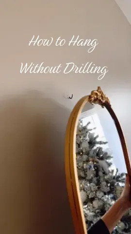 Tip on how to hang heavy objects in drywall without a stud or drilling. #howtohangapicture #monkeyhooks #tipsandtricks #hangmirror #picturehanginghack 
