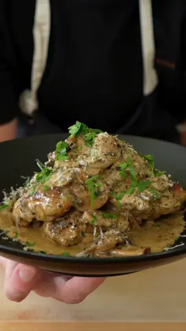My Viral Creamy Garlic Mushroom Chicken   Recipe -  Ingredients - For The Chicken - 2 tsp (10ml) - Olive Oil For Chicken Seasoning   8 - Large Chicken Thigh, Boneless & Skinless  1 tsp (2.5g) - Onion Powder  1 tsp (2.5g) - Garlic Powder  1/2 tsp (1g) - Dried Thyme 1/2 tsp (1g) - Dried Oregano Salt & Pepper  1 Tbsp (20ml) - Olive Oil For Cooking Chicken Creamy Garlic Mushroom Sauce -  1 Tbsp (14g) - Unsalted Butter 2 - Shallots, Finely Diced   300g (10.5oz) - Swiss Brown Mushrooms  100ml (100g) - Dry White Wine  6 - Garlic Cloves, Minced  1g (0.03oz) - Fresh Tarragon  3g (0.1oz) - Fresh Parsley  300g (10.5oz) - Thickened Cream  50g (1.7oz) - Parmigiano Reggiano, Freshly Grated  Instructions -  1. Add chicken, olive oil, onion powder, garlic powder, dried thyme, dried oregano, and salt and pepper in a bowl. Mix well and set aside.  2. Add the remaining olive oil to a large pan over medium-high heat and sear the seasoned chicken in batches for 6 minutes on each side or until deeply golden and cooked through. Remove, set aside and repeat with the remaining batch.  3. Add the unsalted butter and shallot and cook for 1 minute. Add in the mushrooms and salt to taste  and sauté for 6 minutes. Add the garlic and sauté for 45 seconds to 1 minute, mixing the whole time. Deglaze with the wine or chicken stock and cook for 1 1/2 minutes or until reduced by half.  4. Add in the cream, mix well and bring to a simmer; reduce the heat to medium-low and cook for 5-6 minutes or until thickened. Add the parmesan cheese, flat-leaf parsley, tarragon and seasoning to taste. Mix to combine. Add the chicken back into the sauce with the resting juices and coat the chicken well. Cook for 1 minute.  Remove from the stovetop.  5. Serve in bowls or plates and garnish with flat-leaf parsley, cracked black pepper and parmesan cheese. Dig in. 