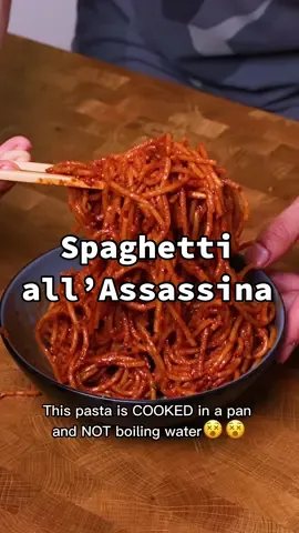 Spaghetti all’Assassina #spaghetti #assassinpasta #pasta  Ingredients: 200g of pasta 3 tbsp of olive oil 3 cloves of garlic, minced 2 tsp of red chili flakes Tomato broth: 1 cup of tomato passata 1 tbsp of tomato paste 3 cups of boiling water	 1 cube of chicken stock 1 tsp of salt Garnish: Parsley, chopped Parmesan cheese, grated Steps: 1. In a sauce pan, combine water, tomato passata, tomato paste, chicken stock and salt. Bring to a boil and set aside. 2. Heat the oil over medium-high heat. Add garlic and chili flakes, sauté for 1 minute. 3. Add the RAW pasta and toss until well-coated with chili oil.  4. Then, pour tomato broth to pasta. Make sure the pasta is evenly coated with the broth. 5. Cook the pasta until it starts to brown or lightly char.  6. Add more tomato broth to pasta and continue to cook the pasta until it absorbs the flavour and reaches desire doneness. 7. Add more tomato broth if it is too dry or for saucier version. 8. Garnish with more parmesan cheese and chives.