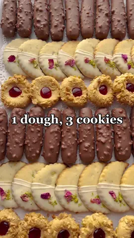 1 DOUGH 3 COOKIES #Ramadan2023 #eid #eid2023 #cookies #fyp #fy #cookbooktiktok #Recipe #food #tiktokfood  COOKIE DOUGH 400 g unsalted butter 225 g powdered sugar 16 g vanilla sugar pinch of salt 2 eggs (m) 10 g baking powder 900 g all purpose flour PISTACHIO LEMON (1) 15 g ground pistachios 3 g lemon zest (0.5 lemon) 100 g white chocolate unsalted pistachios edible rose petals CHOCOLATE COOKIE (2) 5 g cocoa powder 250 g milk chocolate 15 ml sunflower oil 30 g chopped hazelnuts PEANUT COOKIE (3) 125 g unsalted peanuts 1 egg white (m) 30 g granulated sugar 60 g strawberry jam Place the butter in a deep bowl. Add the powdered sugar, vanilla sugar, and salt. Mix. Add the eggs one at a time to the bowl. Mix. Add the flour and baking powder. Knead until smooth. Divide the dough into 3 pieces, 540 g each. DOUGH 1 Take a piece of the dough and place it in a deep bowl. Add and mix the ground pistachios and lemon zest. Place the cookie dough on a floured surface. Roll out the dough (thickness 0.5 cm). Take a cookie cutter and cut out the desired shape. Place it on a sheet of parchment paper.   DOUGH 2 Take the second piece of dough and place it in a deep bowl. Add the cocoa and mix. Take a piece of the dough (20 g) and shape it into a ball. Roll into a stick (8 cm long) Place the chocolate sticks on parchment paper. DOUGH 3 Take some of the dough (18 g) and roll it into a ball. Place the egg white and ground peanuts in separate bowls. Take a ball and flatten it. Dip it in the egg white and then in the chopped peanuts. Press your index finger into the dough to create a hole and place on parchment paper. Cook the jam and sugar until it starts to bubble and the sugar has dissolved. Let it cool and put it in a piping bag. FINISHING  Bake the cookies for 10-15 minutes in a preheated oven at 190 ℃. Fill the peanut cookies(1) with the jam. Melt the white chocolate. Dip the pistachio-lemon cookies(2) into the melted chocolate and place them on parchment paper. Put the remaining white chocolate in a piping bag. Garnish each cookie with chocolate stripes, pistachios, and rose petals. Let the chocolate harden. Melt the milk chocolate together with the sunflower oil. Dip the chocolate cookies in it and let it harden.