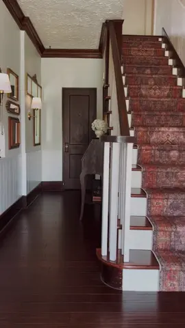 Makeover on this dark entryway, added so much light with paint, sconces, and a mirror gallery wall. Most of all this stair runnwr has my heart. ✨ #entryway #entrywaymakeover #roommakeover #stairrunner #oldhouse #oldhomerenovation 