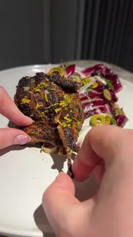 I am so excited to finally show you all quail! I grew up eating it so I was a little nervous to make it (my parents watch my videos so I really didn’t want to mess this one up 😂) Quail to me tastes like a mix between chicken and duck. Though they are much smaller if you cook them right the texture is super soft and juicy. I always prefer mine spatchcocked with slightly charred crispy skin!  For the marinade I used rosemary dressing, chipotle honey vinaigrette, garlic powder, and olive oil. I feel more of a vinegary marinade will help cover some of the gamy flavor. I then pan fried the quail and basted it in garlicky rosemary butter. The result was crispy, juicy, and delicious quail! One of my favorite restaurants in the world called JK’s in North Carolina makes an incredible quail salad, so that was my inspiration for this!  For the salad I used radicchio, pickled veggies, ramp brine, olive oil, dill, pink lemon juice, and charred blueberries! Ramos are a little bit more bitter than regular lettuce and the sweetness of the blueberries really balanced that out. Finally I added some sumac, ramp salt, and lemon zest to finish the quail. I am so happy with how this one turned out 🥹 #quail #TikTokTaughtMe #radicchio 