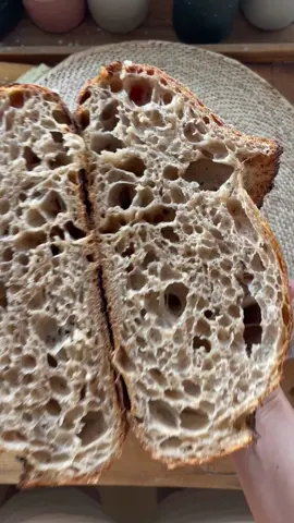 Purple Wheat Flakes Porridge Sourdough Porridge 37.5g purple wheat flakes (any flake/oats works) 112.5g water 7.5g pumpkin agarve syrup (or maple or molasses or any sweetener) Cook on low heat until thick. Cool down. Preferment 20g sourdough starter 40g water 40g wheat flour Mix the night before, use in the morning.  Main Dough 200g wheat type 550 (like bread flour) 200g wheat type 812 (like T80 flour) 100g whole purple wheat (or any whole wheat) 150g porridge 400g water 100g preferment 10g salt   Mix water and preferment, then add flour until combined. Rest 30min and mix in salt until fully combined. Add porridge and mix until fully combined and stable.  Move to a bowl and do some folds to create tension. I did 6-7 every 30-60min. Pre shape, rest 30min and then final shape. Rest 30min and then stitch. I put this one in the fridge at the 9h mark. Find your time. Poke the dough, if it leaves a little dent for a moment and feels wobbly it‘s ready. Fridge for 18h.  Baked in a preheated (around 260°C) cast iron pan, 20min at 260°C and 18min at 230°C. Cut into 20min past baking, best to wait 60min though as it‘s still baking while cooling down and cutting early will make it feel „raw“. 😇 #sourdough #realbread #tutorial #asmr #foryou #opencrumbmastery  #Videoleap 