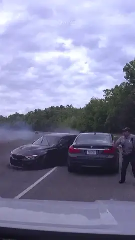 The moment a US police officer is narrowly missed by an out-of-control car during a traffic stop. Only minor injuries were reported. #crash #US #7NEWS 