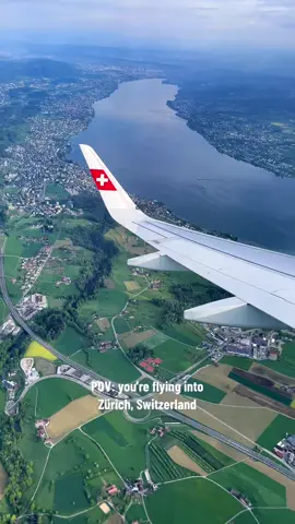the views flying into switzerland might be some of the best there are #travelingvideos #airplaneviews #switzerlandtravel #zurichlakeview #swissview #inflightvideo #cityviews 