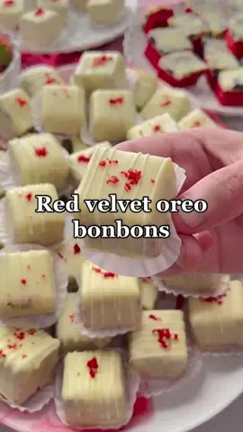 RED VELVET OREO BONBONS #Recipe #foodtiktok #tiktokfood #food #cookies #chocolate #redvelvet #bonbon #fy #fyp #viral #trending RED VELVET COOKIE DOUGH 175 g unsalted butter 200 g white caster sugar 8 g vanilla sugar (1 sachet) a pinch of salt 2 medium eggs red gel food coloring 220 g flour (all purpose) 5 g baking powder 8 g cocoa powder   OREO GANACHE 350 g white chocolate 125 ml whipping cream 75 g Oreo cookies   COATING 700 g white chocolate You can make 70 cookies with this recipe INSTRUCTIONS   In a large bowl, combine the softened unsalted butter with the white caster sugar, vanilla sugar, and salt. Mix until smooth. Add the eggs one at a time, mixing well after each addition. Add the red gel food coloring and mix again. Sift the flour, baking powder, and cocoa powder into the bowl. Mix until fully combined.   Spread the red velvet cookie dough evenly on a baking tray lined with baking paper.   Bake the red velvet in a preheated oven at 175°C for 20-30 minutes. Keep an eye on the baking time, as every oven is different.   Bring the whipping cream to a boil. Add the broken white chocolate (350g) and let it sit for 1 minute. Mix until fully combined.   Chop the Oreo cookies into small pieces.   Add the chopped Oreos to the white chocolate ganache and mix well.   Spread the Oreo mixture on top of the red velvet and distribute evenly. Cover and refrigerate until the ganache is firm.   Cut the red velvet cake into small cubes and place them in the freezer for a while until they become cold (this will help the chocolate to harden quickly and look nice).   Melt the white chocolate (700g) in a double boiler. Put the melted white chocolate into a small deep bowl and put a small amount into a piping bag (for the lines).   Dip the red velvet cubes into the melted white chocolate and place them on a sheet of baking paper.   Decorate the red velvet cubes with lines of chocolate and red velvet crumbs.    