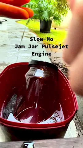Slow motion of a small jam jar jet i made. Running on a low pressure system It uses roughly 50ml of methylated spirits as fuel with about a 12mm hole in the top. The water helps it to somewhat regulate temperature but it did end up breaking anyway. Bit of a nerdy experiment but its a pretty cool trick to do at night #fyp #pulsejet #slowmo #combustion #science #backyardshinanigins 