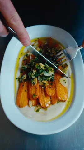 Carrot and Butter Beans - Another Day In Paradise  Ingredients || serves 2  8 carrots  1 large white onion thinly sliced  4 cloves garlic thinly sliced  4 sprigs thyme  1/2 cup white wine, stock, or water  1 tin butter beans with liquid  1/2 lemon juice 1 tbsp cider vinegar  2 tbsp Olive oil  Salt to taste  Garnish  2 tbsp flaked almonds  1 jalapeño minced  parsley finely chopped  Squeeze of lemon  Pinch of salt & sugar  Peel the carrots before steaming for 7-10 minutes. Shock in cold salted water. Cut lengthways and fry in on a medium heat with a generous amount of olive oil - ideally with a weight (you can use a heavy pan). For the bean purée add the thyme, onions, and garlic to a pan with a generous amount of olive oil. Sauté on a medium heat until soft and lightly browned - add the wine and simmer for about 5 minutes. Transfer to a blender along with lemon juice and vinegar. Blend for 2 minutes on a medium speed - then an additional 2 minutes on high. Add a splash of water to loosen if needed. Season with salt to taste.  Toast the almonds and chilli in the same pan that you cooked the carrots for about a minute. Add the parsley, lemon juice, olive oil, and a pinch of salt and sugar.  #fyp 