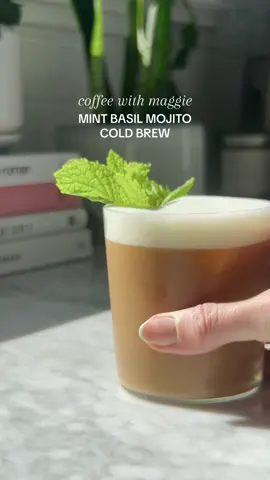 Obsessed with all things herbal and this #mintbasilmojito cold brew is no different. Inspired by a drink i saw @Partners Coffee post, this at home recipe tastes like inbox zero on a summer friday: invigorated, relaxed and maybe a little reckless ✨ To make:  1 cup cold brew coffee 4-5 fresh mint leaves 3-4 fresh basil leaves ½ cup sugar, ½ cup water  ¼ - ½ cup oat milk To make:  🌱Make your Mint / Basil simple syrup: add ½ cup sugar and ½ cup water into a small saucepan. Add in your mint and basil, and bring to a low boil until the mixture is reduced by half. Allow to cool, strain out the mint and basil, and pour into a sealable container.  🧊In a large glass, add your ice, approx. 1 tbsp mint basil syrup, and your cold brew. Stir gently to combine.  ✨ In a separate glass froth the oat milk until it’s your desired consistency. Slowly pour the oat milk over the cold brew and enjoy!!!!   #coffeewithmaggie 
