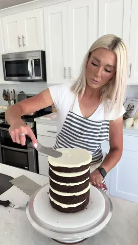 We’ve been living on the baseball fields every day for the past 4 days, and so I’ve got some awesome tan lines to show off to you all. 😉😂  Today I am filling and frosting a few cakes that are going out for the Holiday this week, and wanted to bring you guys along for one of them.  Think of this video as a “Mini cake class”  This cake flavor is 3X Chocolate Mousse Cake. For the exterior, they wanted a bright white buttercream base with painted buttercream accents, sprinkles and macarons. I will be decorating the cake in Part 2. #theblondewhobakes #cakes #cake #cakedecorating #food #Foodie #buttercreamfrosting #cakeoftheday #cakevideo #LearnOnTikTok #tiktokpartner #frosting 