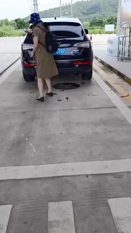 (Posting for journalistic purposes only) woman, checking her rear lights to make sure they’re working 