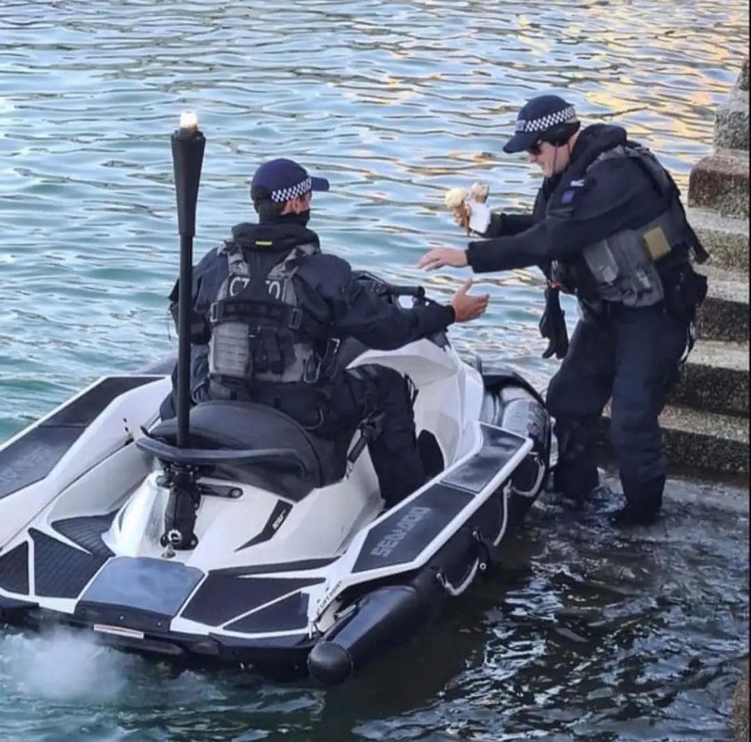 Two ocean patrol officers eating ice cream together on a jetski. #fypシ #summervibes #icecreamday 