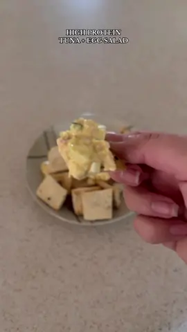 Super quick and easy tuna and egg salad recipe with 55g of protein in a single serving! Paired this with homemade whole wheat crackers, but it can be eaten in a wrap, sandwich or just by itself!  #highprotein #highproteinmeals #lowcarb #pcos #pcosproblems #protein #snackhacks #eggsalad #fyp #foodtiktok 