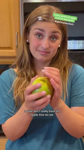 While picking limes in the backyard, Abbey spotted this giant apple growing from a bush so of course she decided to give it a taste test! 🍏 #abbeysautism #hatsbyabbey #snowwhite