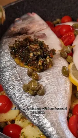 This has to be one of the best and easiest ways to cook fish at home! Let's make Sea Bream with Tomatoes & Potatoes! 🐟🍅 Ingredients 2 medium sized sea bream fillets (scaled and gutted)  150g sweet baby tomatoes  2 medium sized potatoes  3 sun-dried tomatoes  2 cloves of garlic  50g of parsley 1 lemon  White wine Olive oil  Salt & pepper Thinly chop the garlic, sun-dried tomatoes and parsley. Place it into a bowl and mix it with a few tablespoons of olive oil.  Peel and thinly chop the potatoes (5mm thick) and season with salt and half of the garlic mixture.  Layer the potatoes in a large frying pan on a medium heat with a drizzle of oil and fry-steam for 5 to 8 minutes. Add the fish with the lemon slices to the pan, the tomatoes, capers, the wine. Spoon the rest of the garlic mixture on top of the fish.  Cover and cook for 20-30 minutes depending on the size of the sea bream. If it seems like there is not enough liquid during the cooking, add half a glass of warm water. #seabream #tomato #potatoes #fishdish #fishrecipes #mediterraneanfood #cookingathome #seafood #recipeshare #cheflife #italianfood 