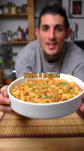 Pasta e Fagioli  is Garden to Fork Ep.21 🍲🌱 🏡👨🏻‍🍳 This dish is full of memories, back to a simpler time, making me feel at home. It’s a comforting bowl of love that I’ve cherished with each spoonful to bring me a tad closer to home for the past 10 years. Simple, yet so much more than just a recipe to me. Hope you enjoy it as much as I do 🥰.  📝 200g Pasta (ditaloni rigati) 2 tbsp Olive Oil 1 White Onion, finely chopped 2 Carrots, grated 1 Celery Stalk, diced 3 Garlic Cloves 2 Potatoes Water as needed (about 2l) 250g Canned Cannellini Beans, drained and rinsed 1 tsp Dried Oregano Salt and Pepper, to taste 1 Bay Leaf Fresh Parsley, chopped for garnish Optional: Vegan Parmesan (from previous recipe), grated or crumbled for topping 🗒️ 1. In a large pot, heat olive oil over medium heat. Add onions, carrots, and celery, sautéing until onions are translucent. 2. Add garlic and sauté for another minute. 3. Mix in crushed pelati, potatoes, water, and cannellini beans. 4. Let the soup simmer until the beans are tender. 5. In the last 10 minutes of simmering, add pasta, cooking until al dente. 6. Mix well, crushing the potatoes slightly, letting the amid from the pasta bind the soup. 7. Serve hot, garnished with fresh parsley and a generous sprinkle of vegan cheese. Buon appetito! 🍝 #veganrecipes #vegantiktok #vegan #italianfood #homemadefood #pastaefagioli #EasyRecipes #plantbasedtiktok #sustainableliving