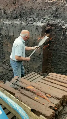 George McDonald cutting turf for burning in his home fire. He's been doing this since the mid 1970s using a special spade that is at least 100 years old. Once dry, the peat bricks will be burnt to keep the home warm.
