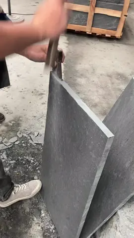 Splitting stones by hand to make textured tiles
