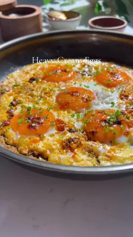 Spicy Heavy Cream Eggs 🥹 something freaking magical happens when you fry eggs in heavy cream…it caramelizes and the results are sublime, especially with a bit of salsa macha or chili crisp! I learned this while working in restaurants and it was a game changer! Ingredients: •4-5 eggs. •1/4 cup heavy cream. •1 tbsp salsa macha + more for topping. •chives to taste. •salsa macha. Directions: 1. Preheat a pan for 2 min on high. Add in heavy cream and chili crisp. Lower heat to medium and simmer for 1 min. 2. Add in eggs and cover. Cook like this for 2-3 min until the whites set. 3. Top with chives, seasoned eggs and chili crisp. #eggs #eggrecipes #friedeggs #sundaybrunch #salsamacha #EasyRecipes #tastemade #overeasyeggs 