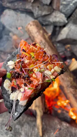 We’re back with more BEACH FOOD! 🔥 Lia and @outdoorcheflife made charcoal flat bread by crushing coals from the fire, adding it to a flour mixture, stretching it out and cooking it over an open fire. Topped with smoked salmon, roe, a little cheese, microgreens and two Barnacle goodies: Habanero Kelp Hot Sauce and Kelp Chili Crisp. 🌶️ Tell us: would you take a bite?! 