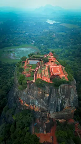 LIONS ROCK Majestic Lions Rock in Sigiriya, Sri Lanka, rises 660 feet above ground, a marvel of ancient architecture.  Built in the 5th century, it served as a fortress with its lion-shaped gateway, showcasing ingenious engineering.  Today, it stands as a UNESCO World Heritage site, inviting visitors to explore its rich history and breathtaking views.  • • • #visitsrilanka #travelstoke #exploresrilanka #exploreearth #travelsrilanka #bevisuallyinspired #viralreels #roamtheplanet #ninearchbridge #outplanetdaily #PlacesToVisit #beautiful_destinations #folkscenery #theearthoutdoors #traveladdict #travelawesome #theoutbound #earthfocus #lensbible #findyouradventure #voyaged #nomadict #dronemperors #folknature #folkscenery #travelreelsontiktok 