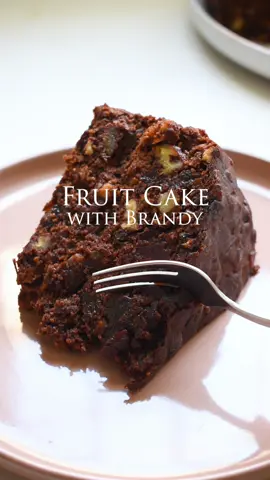 Fruit Cake with Brandy 🍊🍇🍒🥃 Yoh! I could honestly devour this one big tasty bite at a time and I ain’t joking… it’s actually a problem so I’m risking my mental health here for all you keen recipe-lovin-tastebuds 😂 500g dried fruit mix (dried raisins etc.) 200g orange peel, finely diced 200g glazed cherries, whole 200g pecans, roughly chopped 250g dried dates, roughly chopped 250ml brandy 50g all-purpose flour 125g butter, room temperature 300g light brown sugar 5 large eggs, room temperature 200ml golden syrup 360g all-purpose flour 50g cacao powder 1 tsp mixed spice Good pinch of salt 30g fresh ginger, finely diced 2,5g baking soda 30ml brandy Add the dried fruit, orange peel, cherries, pecans and dates to a large bowl and pour over the brandy. Mix and microwave for 3 minutes, stirring every 30 seconds or allow the fruit to soak in the brandy mixture overnight. Preheat the oven to 140 degrees celsius and prepare a 25cm cake tin by lining it with one layer of baking paper on the base but 4 layers on the sides. Add the 50g flour to the soaked fruit and set aside. Whisk the butter and sugar together until lighter in colour. Gradually add in the eggs. In a separate but large bowl, add the 360g flour, cacao powder, fresh ginger, baking soda, mixed spice and salt together and mix. Add the golden syrup and brandy and mix until incorporated. Gradually add in the dried fruit mixture and mix until well incorporated. Add the fruit cake batter to the lined cake tin. Bake the cake for 25mins at 140 degrees celsius and then lower the heat to 120 degrees celsius and bake for 3 hours. Remove from the oven and allow to cool. Once cooled, remove from the cake tin and place on top of a large sheet of foil. Brush 30ml of brandy on top and tightly wrap it in the foil and glad wrap and allowing it to rest on the kitchen countertop. Soak 1 a week  for 1 week min or 4 weeks maximum. #fruitcake #brandy #christmasrecipes #oumasrecipes #cake #tummy #dessert #southafrica #southafricanfoodie