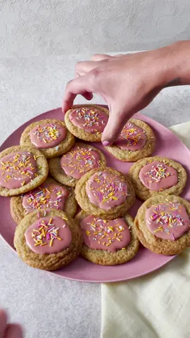 School cake inspired cookies 🍪 Makes 30 V  Takes 55 mins, plus chilling 150g unsalted butter, softened 250g soft light brown sugar 1 tbsp Madagascan vanilla bean extract  1 egg, lightly beaten  225g plain flour ½ tsp bicarbonate of soda  To decorate  100g icing sugar red food colouring 4 tbsp colourful sprinkles  1. In a large bowl, beat the butter, sugar and vanilla extract together until well combined, but not pale and fluffy. Stir through the egg, then beat in the plain flour and bicarbonate of soda.  2. Shape the mix into 30 even-sized balls (roughly 20g each) and chill in the fridge for 2 hrs, or up to 24 hrs, until firm.  3. Preheat the oven to 190°C, fan 170°C, gas 5. Meanwhile, line a large baking tray with parchment and, working in batches, place the cookie dough balls on the tray roughly 5cm apart. Bake for 9-10 mins until slightly golden around the edges, but pale in the centre. Cool on the tray for 5 mins, then transfer to a wire rack to cool fully. Repeat with the remaining dough. 4. Once the cookies are cool, mix the icing sugar with 1½ tbsp water and drops of food colouring to get your desired shade of pink. Spoon and smooth the icing over the cookies and top with the sprinkles. Leave to set for 20-30 mins before serving.  5. Store in an airtight container for up to 5 days. Tip: Freeze the cookie dough balls for up to 3 months in an airtight container.  Cook from frozen in the preheated oven for 12-13 mins. #tesco #EasyRecipes #cookies #schoolcake 