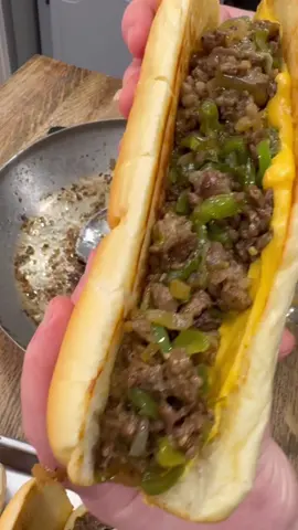 Cheesesteak Sandwiches are easy to make and so good! 🔥  INGREDIENTS 1 1/2 lbs ribeye steak Salt, pepper, garlic powder Steak Seasoning  1 onion 4 tbsp butter 2 green peppers Provolone cheese slices Cheese Whiz 4 hoagie rolls Mayo INSTRUCTIONS Thinly slice steak and set aside. Thinly slice an onion and 2 green peppers. Spread hoagie rolls with mayo. Heat a skillet over medium high heat and quickly toast the hoagie rolls. Once rolls are toasted remove them from the pan and set aside. Add 2 tbsp of butter to the skillet. Cook peppers and onions seasoned with salt, pepper, and garlic powder until tender. Remove them from the pan and set aside. Cook steak in the hot skillet and add 2 more tbsp of butter if needed. Season steak with some steak seasoning. Once steak is cooked to your liking add the peppers and onions back to the skillet. Top skillet with provolone cheese. Stir together steak, veggies, and melted cheese.  Spread cheese whiz on the toasted hoagie rolls. Stuff hoagie rolls with the steak mixture.  Top with more provolone cheese and place sandwiches in a baking dish or sheet pan and bake at 400 for just a few minutes to melt the extra cheese. Enjoy! #Recipe #dinner #cheesesteak #sandwich #EasyRecipes #meals 