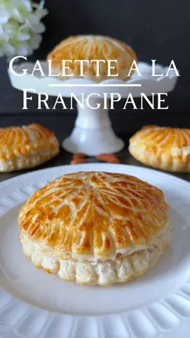 Galette à la Frangipane Recipe 🤍 Galette à la Frangipane is a tempting recipe that combines the delicate crispiness of puff pastry with a filling of creamy almond cream 🥰 📝 Ingredients: For 6 Galettes with a 10 cm diameter - 100 g ground almonds - 75 g powdered sugar - 50 g softened butter - 1 egg - 1 teaspoon almond extract - 2 sheets of puff pastry - 1 egg yolk (for brushing)  🤍 Preparation: 1. Preheat the oven to 200 degrees Celsius. 2. For the Frangipane Filling, combine ground almonds, powdered sugar, softened butter, egg, and almond extract in a bowl until a smooth cream forms. 3. Place one sheet of puff pastry on a baking sheet. 4. Spread the Frangipane cream over the puff pastry. 5. Place the second sheet of puff pastry on top and seal the edges securely. 6. Whisk the egg yolk and brush it over the puff pastry. 7. Create a pattern on the surface with a fork or skewer. 8. Bake the Galettes for approximately 20 minutes or until golden brown. 9. Allow to cool after baking and dust with powdered sugar. Enjoy your Galette des Frangipane! ☺️🤍