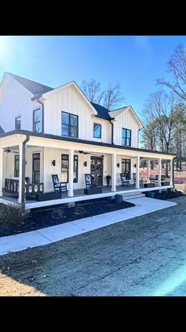 Blue wreaths and blue pillows make for a comfy winter front porch!  #frontporchdecor #frontporchdecorating #wintervibes #winterdecor #whitefarmhouse #exteriordesign #tiktokhomes #homeexterior #modernfarmhouse #housedesign #homes #homedesign 