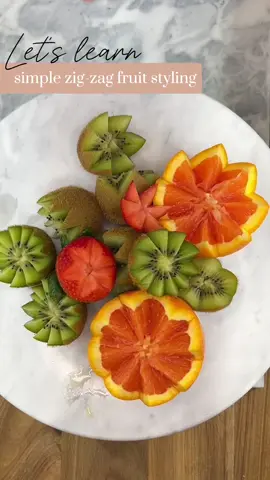 — Zig-Zag Fruit Styling — here’s a quick tutorial on styling fruits with the zig-zag or “star” cut to elevate your plating! such a simple technique that adds elegance to your boards and trays✨ — using a paring knife, make a slanted incision in the middle of the fruit to the mid-point, and continue this pattern until you meet the point of beginning — simply pull the fruit apart to reveal the gorgeous cut. you can change the design by how far you space your cuts apart, so play around with it to reach your desired result — this cut is most commonly seen with kiwis, but you can try this on a variety of different fruits and vegetables! try it out and tag me in your results! happy styling✨ ——— #fruitstyling #fruitart #charcuterie #charcuterieboard #Foodie #foodstagram #foodstyling #fruit #tips #fyp #foodtiktok #FoodTok 