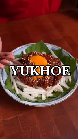 Raw Korean Beef (Yukhoe) 🐮🇰🇷 This is kinda like an asian beef tartare! I love this especially when paired with rice and an ice cold 🍻  Very simple to make but so good! INGREDIENTS: - 500g beef tenderloin, cut into thin strips - 1 stalk onion leek, sliced - 8 cloves garlic, minced - 2 tbsp rice syrup - 3 tbsp soy sauce - 1 tbsp sesame oil - 1 tbsp gochujang - Pepper to taste - Korean pear,  cut into matchsticks) Garnishes: - Egg yolk - Sesame seeds INSTRUCTIONS: - mix together your sliced beef, leeks, garlic, rice syrup, soy sauce, sesame oil, gochujang and pepper. You can serve immediately or marinate for a couple of minutes. - Serve on top of sliced Korean pear and garnish with sesame seeds, egg yolk and enjoy! #yukhoe #beeftartare #koreanfood #asmr #cookingasmr 