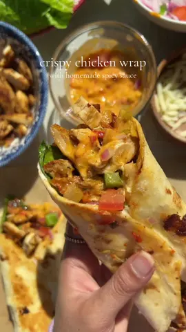 Crispy chicken wrap recipe 🌯 Ingredients  4 tortillas  2 medium chicken breast thinly sliced  2 tomatoes finely diced 1 red onion finely diced  1 green bell pepper  1 cup shredded cheese ( mozzarella or cheddar) Seasoning for chicken  Salt to taste 1 tbsp fresh garlic minced  1 tbsp chopped coriander  3-4 tbsp cajun seasoning  1 tbsp red chili flakes  2 tbsp fresh lemon juice  2 tbsp soy sauce ( low sodium ) Oil for cooking  For spicy sauce  1/2 cup mayonnaise 2 tbsp chopped jalapeños 1 tbsp Sambal oelek sauce ( or you can use any chili sauce + 1/2 tbsp red chili flakes) 1 tbsp fresh garlic finely minced Salt to taste 1 tbsp black pepper 1 tbsp lemon juice Instructions  To grill chicken Mix all the spices,garlic and coriander. Coat chicken well in the marinade. Add lemon juice. Heat the pan with some oil. Add the chicken. Cook for 15-20 minutes on both sides, or until fully cooked.  For the spicy sauce mix all ingredients in a bowl listed above.   To Assemble Chicken Wrap:  On a tortilla, Add Lettuce leaves, chicken. Drizzle dressing and top it with onion tomato and bell peppers.Add cheese and spicy sauce. Roll it tightly, heat a grill pan. Cook the wrap on both sides until you see light grill marks for about 1 minute on each sides. #chickenwrap #grilledchickenwrap #spicychicken #burrito #Recipe 