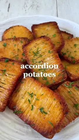 Accordion Potatoes 🥔✨ Try these crispy pull apart potatoes for a fun and delicious snack! Make sure you save all the little offcuts to roast as well because potatoes = life so we’re not letting any of it go to waste 🙊 Serves: 2 Time: Way too long (lol) Ingredients 4 large potatoes 2 tbsp olive oil Generous amount of sea salt & freshly cracked black pepper 1/2 tsp smoked paprika 1/2 tsp garlic powder 1/2 tsp onion powder 1/2 tsp oregano 1/2 tsp dried rosemary Fresh parsley to serve Method: 1. Preheat your oven to 200°C fan forced. Peel your potatoes, then slice off the tops and bottoms followed by the sides to create flat edges. Slice down lengthways to create 3 even thick pieces. 2. Place between a pair of wooden chopsticks and slice vertically. Flip then slice diagonally. Repeat with all the potato slices then place onto a lined baking tray. 3. In a small bowl, mix together the olive oil, salt, pepper, paprika, garlic powder, onion powder, oregano and rosemary. 4. Brush oil mixture over the potatoes to evenly coat each slice then bake in the oven for 30 minutes or until side facing up is golden. Flip and bake for another 20 minutes or as long as you need until golden and crispy. 5. Transfer to a plate and garnish with fresh parsley. Enjoy immediately while hot and crispy! Okay sooo in all honesty… Do they taste good? Yes. Are they fun to pull apart and eat? Sure. Is it worth the time and effort? Mmm nah. You’re better off chopping up your potatoes as normal before airfrying or baking them. But hey, gotta keep it interesting for the gram am I right 🫣 Nevertheless I still had a great time making and eating them so if you’ve got time then definitely give it a go! 🤭 📹@thrivingonplants #vegan #plantbased #EasyRecipe #recipeidea #homemade #potatoes #potatorecipes #potato #asmrfood