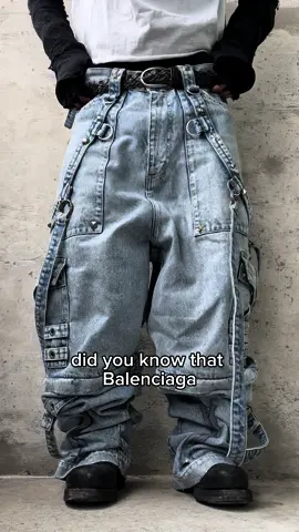 Balenciaga SS22 Oversized Raver Cargo Denim Demna Gvasalia emerged as a trailblazer in the fashion industry, initially gaining recognition as the co-founder of Vetements. The brand disrupted conventional fashion norms with its deconstructed aesthetic and edgy streetwear influences. The oversized ‘Raver’ denim, with their exaggerated silhouettes and insane detailing, encapsulate the fusion of subculture and haute couture. Demna has masterfully captures the dynamism and energy of rave culture, transforming it into a high-fashion statement. Size 33, available to purchase/rent via our website.  Do you rave? 🪅 #balenciaga #demna #demnagvasalia #archive #archivefashion #fashionarchive #fashionarchives #fashion #fypシ #fashiontiktok 