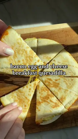 ✨ bacon egg and cheese breakfast quesadilla ✨ Scramble 2 eggs and po into a greased pan over medium heat allow the eggs to cook along the bottom and then reduce the heat to medium low. Place a tortilla on top flip it over and place some bacon and shredded cheese on top of the egg layer. Place a second tortilla on top spray the top allow that to cook a little bit for the cheese to melt. Flip once more and finish cooking then cut into slices. I usually use a low-carb tortilla or almond flour tortilla for this. ##EasyRecipe##breakfastideas