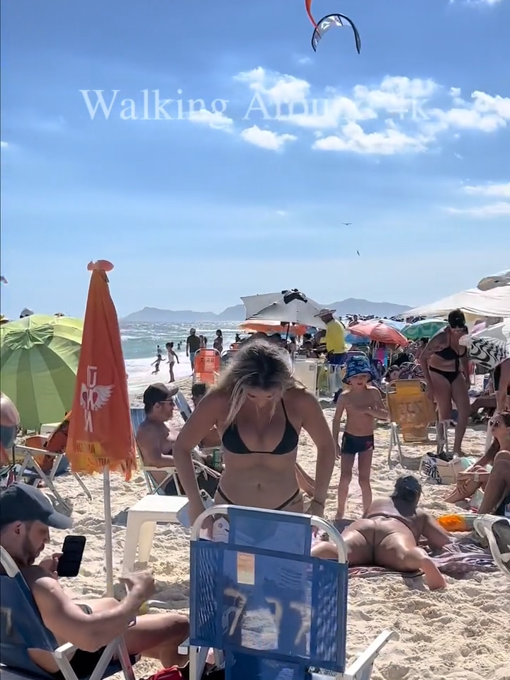 🌴 Summer at Rio de Janeiro. Walking on one of the most famous beaches in Rio de Janeiro in Brazil, Praia da Barra da Tijuca is the preferred place for those who want to relax and cool off on the hottest days during the summer. I walked on the sand to show what a Sunday morning is like, follow the video with many beautiful people in bathing suits, beautiful women having fun posing for photos, and enjoying the day. Barra da Tijuca is a neighborhood in the West Zone of the municipality of Rio de Janeiro, Brazil. The neighborhood is part of the administrative region of Barra da Tijuca. It has, as neighboring districts, Itanhangá, Camorim, São Conrado, Jacarepaguá, Recreio dos Bandeirantes, Curicica and Joá. Like Jacarepaguá, it is one of the neighborhoods that grew the most in Rio de Janeiro at the turn of the 20th century to the 21st century; went from 24,126 inhabitants in 1980 to 394,037 inhabitants in 2020. Currently, it is considered a financial, gastronomic, hotel and entertainment center of the state capital. It has been the target of migration from other neighborhoods in the municipality. It is estimated that Barra's population will double by 2030. In 2020, its quality of life index was evaluated at 0.972, reaching the 1st place in Rio de Janeiro, among 126 evaluated neighborhoods. The full video is available on our channel, Link in bio, Playlist: Rio de Janeiro Beaches. 