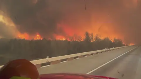 Texas Crew Drives Through Leaping Flames in Fire-Hit Panhandle The intensity of fire activity in the Texas Panhandle on February 27 was dramatically shown in video recorded by a crewmember from Greenville Fire-Rescue as their truck drove through leaping flames, sparks and smoke during their response in the area. Greenville Fire-Rescue said it had deployed teams in Canadian and Wheeler in the Panhandle, and were “proud to have the capabilities and training to help other communities in their time of need.” The Smokehouse Creek Fire had burned through more than 300,000 acres of land by early Wednesday. Authorities issued evacuation orders on Tuesday afternoon for parts of Hemphill County as the fire encroached on populated areas.  #news #fyp #texaswildfires