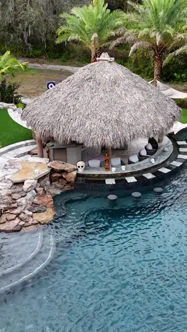 This is one of our most insane backyards, and it is definitely one of the top pools we have ever built. It's got a Tiki Hut outdoor kitchen with a swim-up bar. It's a massive pool with a huge infinity-edge hot tub, grottos, upon grottos, upon grottos, and a dry cave behind the grottos. It's super lush and tropical. #insanepools #lucaslagoons #pool #poolbuilders #backyard #luxurylife #tikihut 