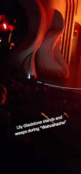 Lily Gladstone stands and weeps during 