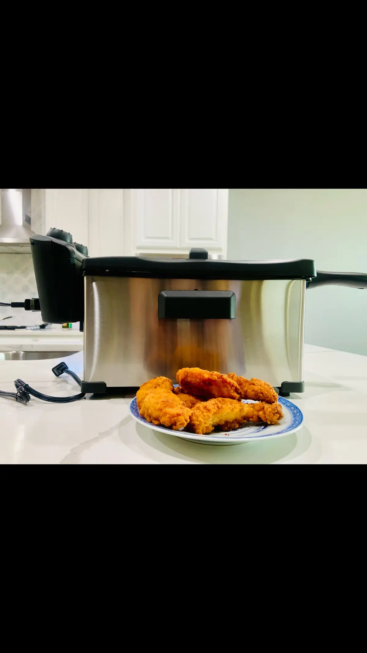 Tk you @Influenster and @elitegourmet for allowing me to try the #élitegourmet  EDG-3500 Electric Immersion Deep Fryer in exchange for my honest opinion.  The Elite Gourmet EDF-3500 Electric Immersion Deep Fryer was developed with a sleek brushed stainless steel body and an enamel non-stick detachable oil compartment that is fully immersible and dishwasher safe. The vented cool touch lid has a viewing window, a charcoal air filter to absorb unwanted odors and help prevent oil splatters. I decided to fry some chicken tenders to test it out. The fryer is very simple to set up and operate.  I fill the oil compartment with oil and there are  designated fill mark lines so there’s no guessing how much to use. I followed the recipe and set it at 360  and it heated up quickly. Now the product claims to fry up to 2.3 lbs of food per batch but I will point out that imo I felt the basket is rather small and feel a larger basket would be more suitable for more efficient frying. Once the oil was hot enough the green light turned off signaling I was ready to begin frying. Since I was only making enough to feed my mother and myself I fried 5 chicken tenders per batch. It has a 30 minute timer which I set because I’m often multitasking and lose track of time whenever I’m cooking.  I was pleased at the short amount of time it took for them to cook which was between 5-7 minutes.  I like that the cool touch  basket handles prevented me from  burning my hands when I took the strips out. Once done I allow  the basket to hang on the hook  so that the excess oil drips off into the container. The fryer cooks evenly and my wings were crispy and delicious. Cleanup is a breeze and I’m loving how convenient and effortless it is  preparing fried foods in my new fryer.  #influenster #elitegourmet #deepfryer #stainlesssteel #enamelnonstick #oilcompartment #fullyimmersive #dishwashersafe #cooltouch #ventedlid  #viewingwindow #charcoaloil #absorbsodors #preventsoilspills #easytouse #convenient #cooksevenly #easycleanup #quickfrying #producttester #producttesting #reviewer #giftedbyinfluenster #honestreview #contentcreator