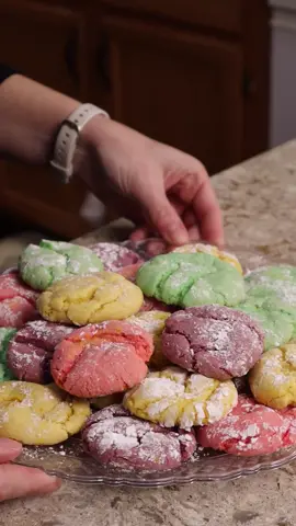 You can make this colorful Easter cookie platter from a single box of cake mix!  You will need: 1 box of vanilla cake mix 1/2 cup of oil 2 eggs (or swap for 1/2 cup of unsweetened applesauce) Food coloring powdered sugar (optional) Mix the cake mix, oil, and eggs/applesauce until well combined.  Should be a thick cookie dough like consistency.   Divide this evenly between 4 bowls and add food coloring of choice.  We are going for pastel easter colors so I did a couple of drops each of red, yellow, green and for a purple I used 1 to 2 drops of blue and 3 to 4 drops of red. Roll into teaspoon sized balls and dredge in powdered sugar.  Bake at 350 degrees for 12 to 14 minutes and let cool before serving.   #easterdesserts #eastercookies #colorfulcookies #cakemixcookies #easydessert #kidfriendlyrecipe