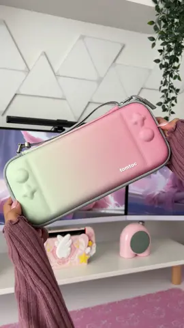 Let’s unbox the Tomtoc Slim Carrying Case for regular and OLED Nintendo Switch in Cherry Blossom gradient. 🌸 Thanks @tomtoc_official for sending this over!🎁✨ This hard protective switch case comes with 10 game cartridges. I love how slim and light it is to carry. It’s also water-repellent and durable.🫶🏻  Link in bio🛒🛍️ #tomtoc #switchcase #unboxing #pastelpink #ａｅｓｔｈｅｔｉｃ #nintendoswitch #nintendoswitchcase #cozygamer #GamingSetup#gamingcommunity #switchbag #kawaiigamer #carryingcase #kawaiiaesthetic #cutebag #switchaccessories #GamerGirl #pinksetup #desksetup #gaminglife🎮 #gamingsetup #nintendoswitchaccessories #girlgamer #switchbag #setupinspiration #pinkswitch #pinkaesthetic #desksetup #switchprotectivecase #nintendoswitchlite 
